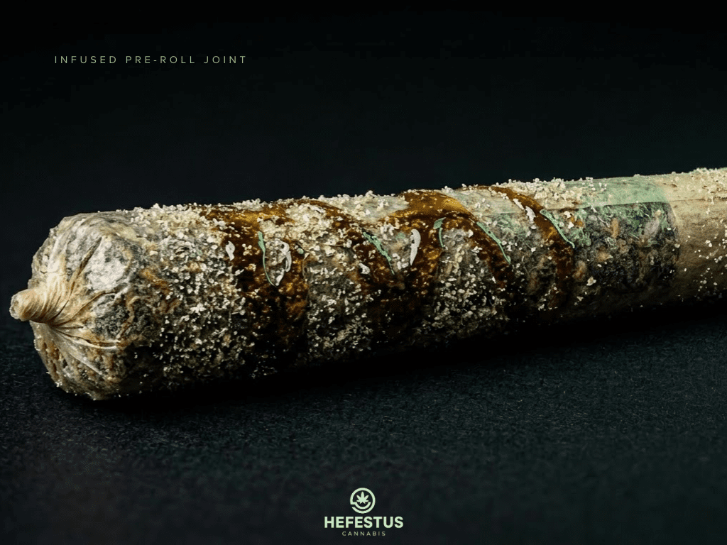 Cannabis infused pre-roll joint with distillate infusion visible along the paper, concentrate glistening under studio lighting, fine kief dusted along the surface, placed on matte black background with soft green accent lighting.