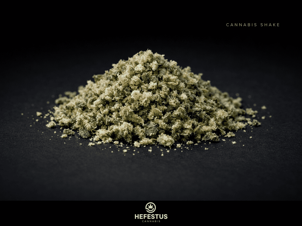 Macro photography of cannabis shake material on matte black surface, mixture of broken cannabis flower fragments, visible trichomes, small bud particles, minimal leaf content